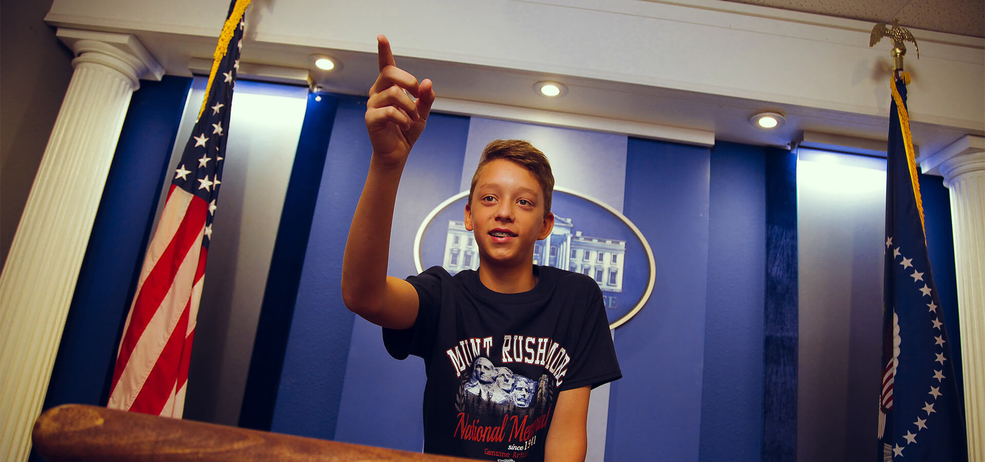 Young visitor at the White House Press Room exhibit.