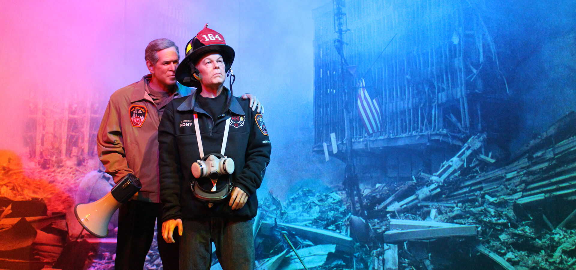 George W. Bush and a First Responder standing at the Twin Towers site shortly after 9/11.