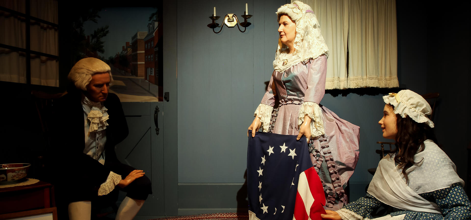 George Washington, with his wife Martha, and Betsy Ross looking at the first American Flag.